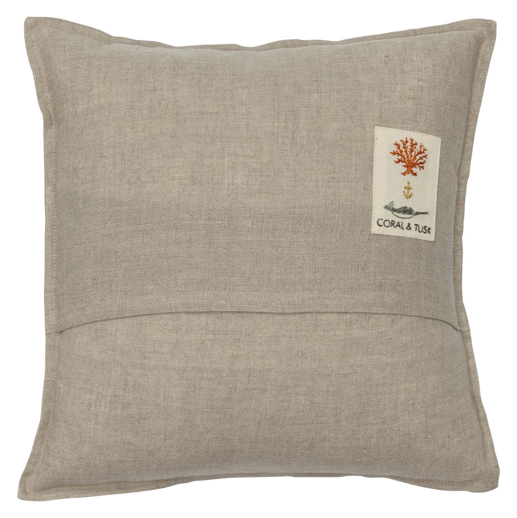 The Coral & Tusk Supermoon Spell Pillow is a square, beige pillow adorned with a small rectangular embroidered patch located in the top right corner. The patch showcases an orange coral design, a small image below it, and the text "CORAL & TUSK." The overall texture of this Halloween-themed pillow resembles linen.