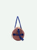 A round, tan Sticky Lemon Duffle Bag with adjustable blue straps, featuring a sleek, minimalist design, against a plain white background.