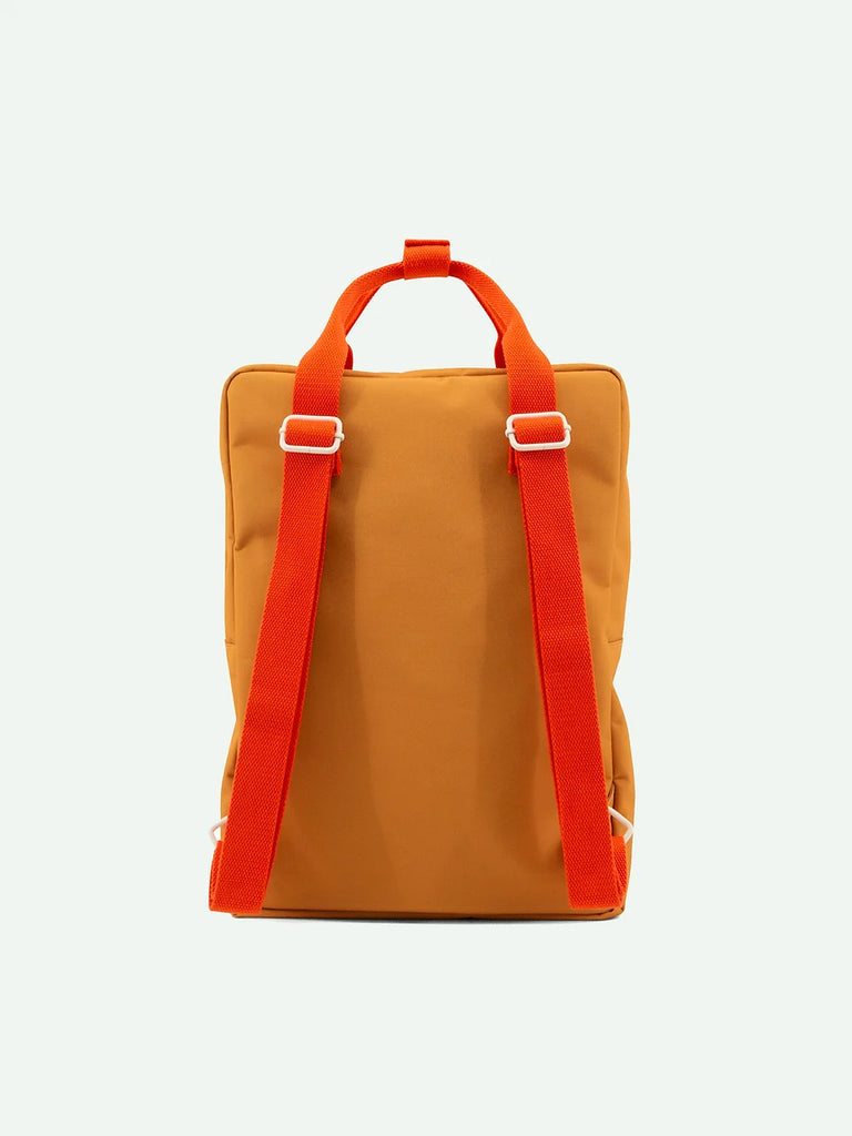 A Sticky Lemon Backpack Large in Farmhouse color with bold orange straps and recycled RPET buckle details, displayed against a plain white background.