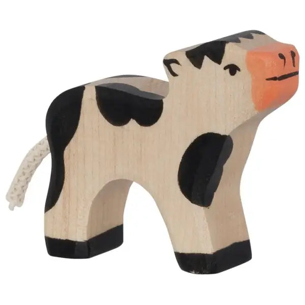 A small, wooden toy cow with simple black and white patterns, a pink snout, and a piece of string as a tail. Handcrafted in Europe, this Holztiger Black Calf figure has a minimalistic and hand-painted appearance.