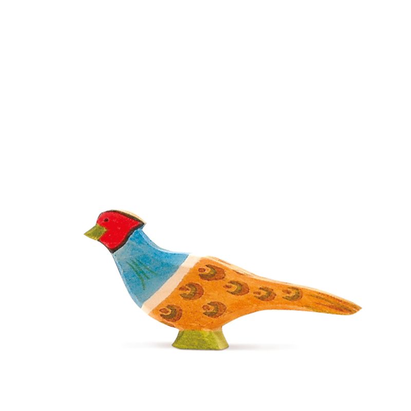 The Ostheimer Pheasant is a colorful, hand-painted wooden bird figurine with a red head, blue neck, and orange body adorned with decorative patterns that stands on a white background. This charming piece, reminiscent of traditional Ostheimer wooden toys, captures the essence of folk art with its simple design and sustainably sourced materials.