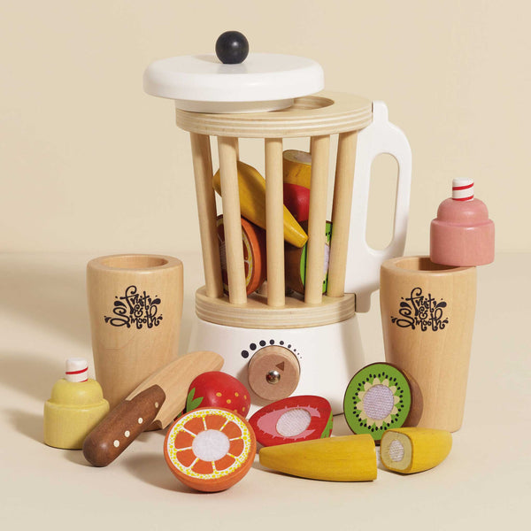 The Fruit & Smoothie Blender Set includes a retro-style wooden toy blender and sliceable fruits such as kiwi, orange slices, bananas, and apples. It also comes with two beverage containers, making it perfect for a vibrant array of playful pretend kitchen activities.