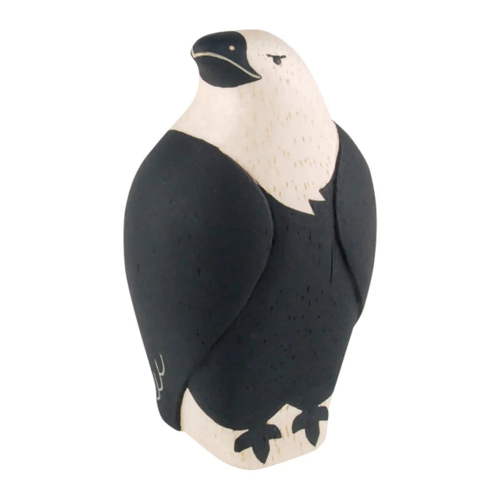 The Handmade Tiny Wooden Forest Animals - Eagle is a minimalist, handcrafted figurine made from Albizia wood. This eagle features a white head and chest, complemented by its black body, wings, and beak. Its small legs are also black, and it includes simple line detailing on the wings and eye.