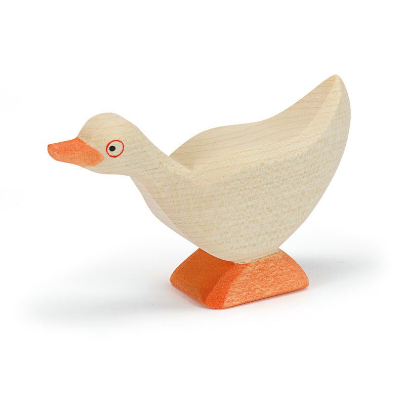 A handcrafted Ostheimer Goose - Standing figure with a simple, stylized design. The body is natural wood color and the base is orange. The goose has a prominent beak and a red eye detail.