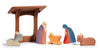 Ostheimer's Manger With Roof is a wooden nativity scene that includes a stable, Mary, Joseph, baby Jesus in a manger, along with a donkey and a cow. These handcrafted figures are simple yet colorful, perfect for imaginative play against a crisp white backdrop.