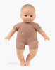 A bald baby doll with brown eyes, dressed in a simple brown one-piece outfit, stands against a plain white background. This Minikane Soft Body Doll (11") - Matteo is made from phthalate-free vinyl, making it a safe and perfect bedtime companion for your little one.