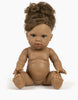 A Minikane Baby Doll (13") - Melissa with a medium skin tone is sitting upright with its legs spread apart and arms extended forward. The doll, boasting anatomically correct features, has curly brown hair styled up and appears unclothed. It also comes with a natural vanilla scent, set against a plain white background.