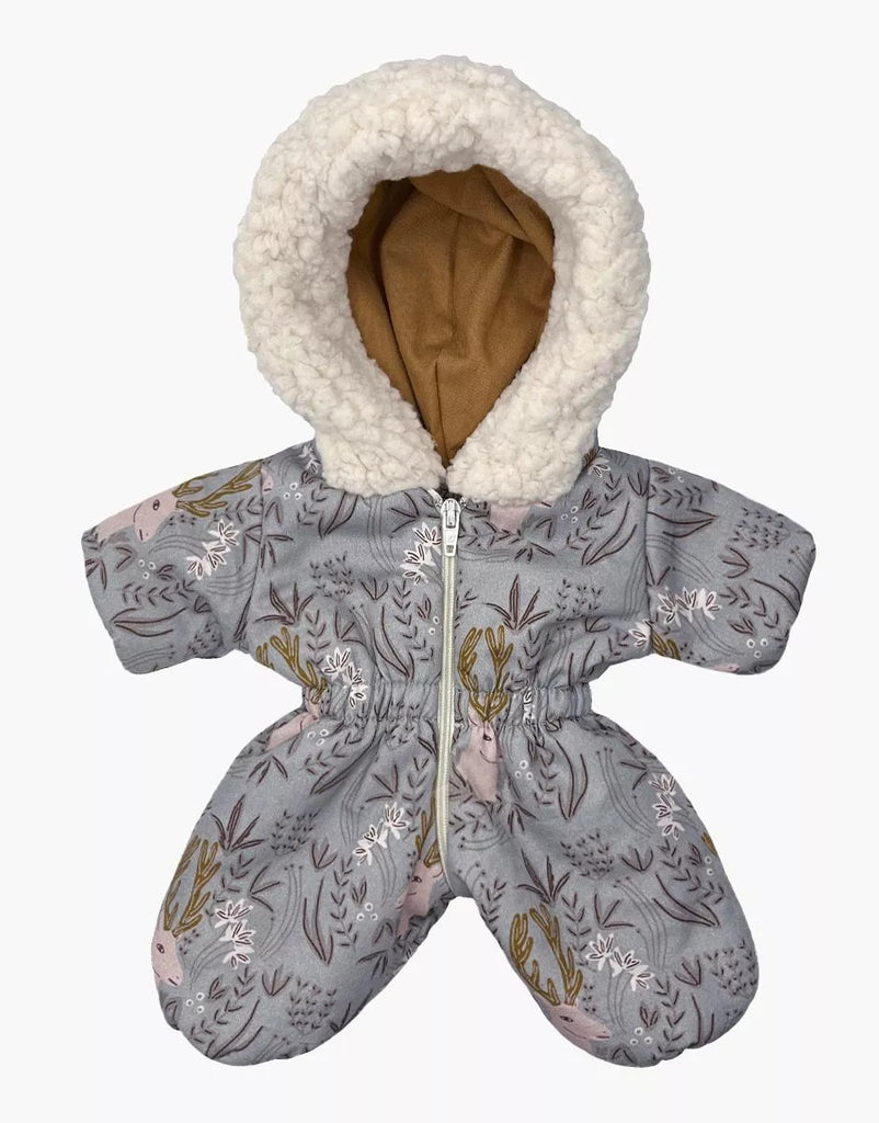 The Minikane Doll Clothing | Gigi Elaphe Ski Suit is a cozy, gray baby snowsuit reminiscent of a classic ski suit. It features a fluffy white hood lining and is adorned with a nature-themed pattern of deer and plants. It offers easy fitting with its front zipper and separated legs, echoing the design quality seen in outfits for Minikane dolls.