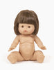 A Minikane Baby Doll (13") - Valentine, with light brown bobbed hair and brown eyes, is sitting on a plain white background. The anatomically correct doll has a chubby body with both arms slightly extended forward and its legs spread apart, exuding a natural vanilla scent. Clothing for the doll is sold separately.