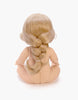 The Minikane Baby Doll (13") - Eleanor is depicted from the back, sitting with legs outstretched on a white background. Her long, light blonde hair flows elegantly in a loose braid down her back, enhanced by a gentle vanilla scent.