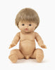 A lifelike Minikane Baby Doll (13") - Achille with light skin and short brown hair, shown sitting with legs apart and arms reaching forward. The anatomically correct doll has detailed facial features, fingers, and toes. It is unclothed against a plain white background and has a gentle natural vanilla scent.