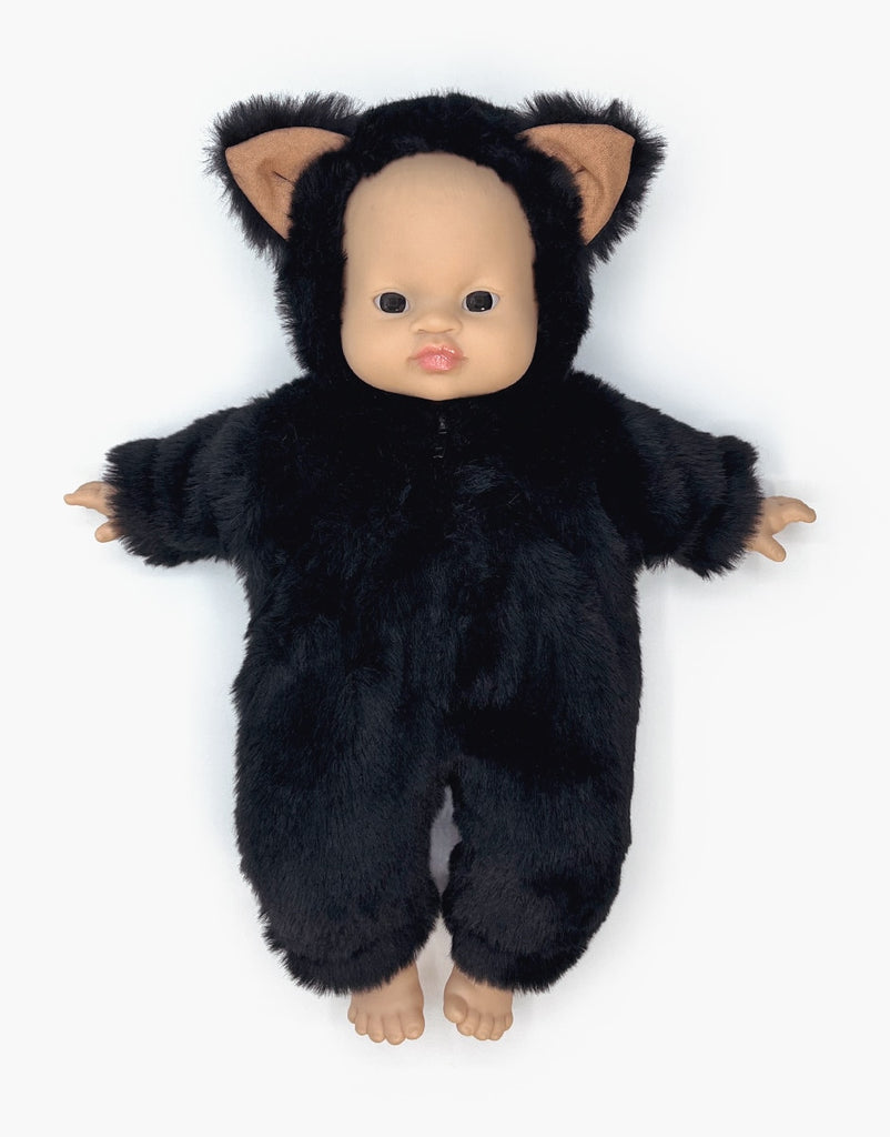 A Minikane Babies Doll is dressed in a Black Faux Fur Costume featuring charming cat ears, giving it an adorable yet neutral expression. Barefoot and set against a plain white background, this charming doll is poised to capture hearts.