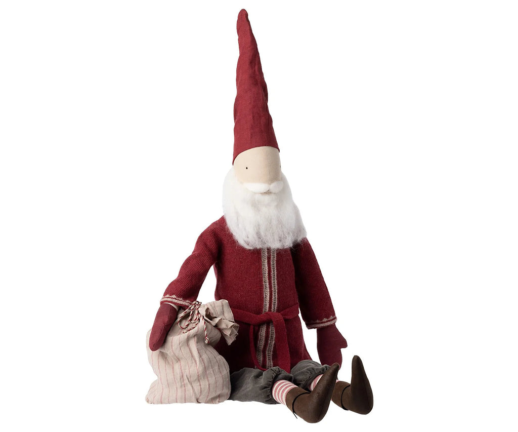 A Maileg Large Santa, standing at 43.30 inches, features a tall red hat, red coat, and white beard. It sits on the ground holding a striped cloth bag tied with string and is adorned with brown shoes and striped socks, perfectly capturing the holiday spirit as a charming decoration.