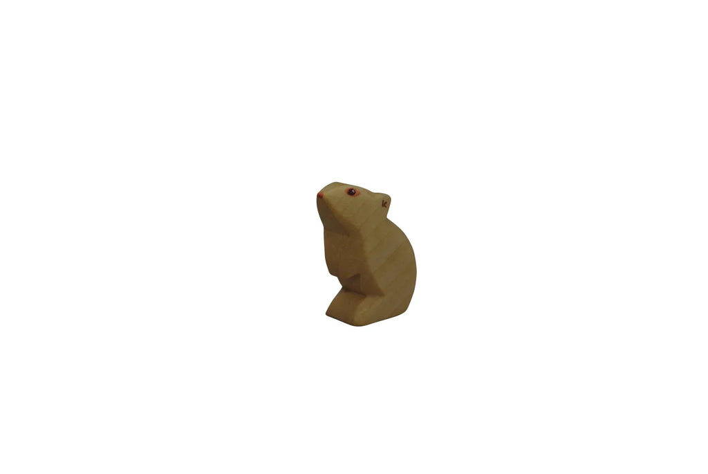 A wooden carving of a Handmade Holzwald Mouse - Standing, standing upright with its head tilted slightly upwards, isolated on a plain white background, crafted from sustainable wooden toys materials.