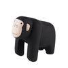 A handcrafted wooden gorilla from the Handmade Tiny Wooden Safari Animals collection stands on four legs, showcasing a natural wood face and a black painted body. It features a simple, smiling face with minimalist details, crafted from Albizia wood, giving it a charming and playful appearance.