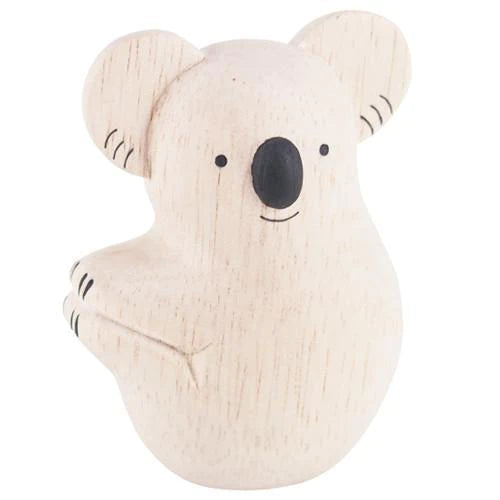 The Handmade Wooden Koala is a small, light-colored figurine crafted from Albizia wood. It features minimalistic design elements, including black eyes, a black nose, and simple lines to represent its arms and ears. The surface of the handcrafted koala displays a natural grain pattern.