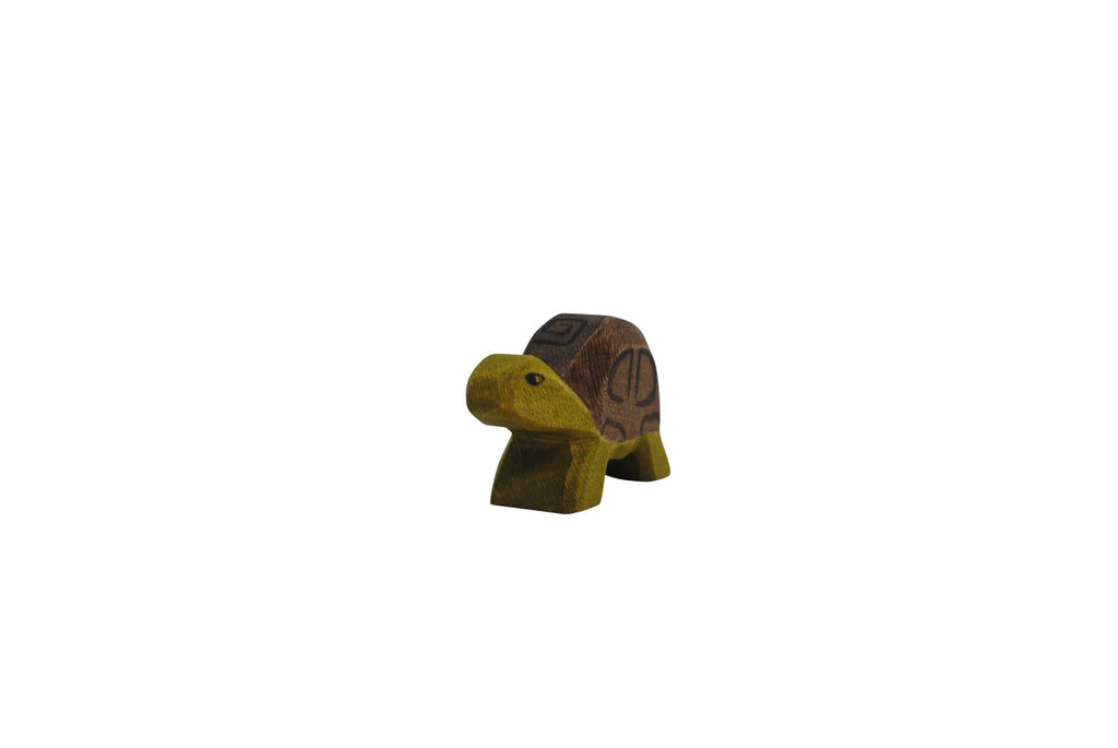 A Handmade Holzwald Small Turtle wooden figurine, showcasing detailed carvings and natural wood patterns, isolated on a plain white background.