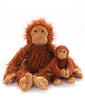 Two "The Orangutans Stuffed Animal" toys sit together against a white background, embodying a tender mother-daughter bond. The larger one boasts long, fuzzy orange fur and a cheerful expression, while the smaller one has shorter, smooth fur and is slightly curled up with a similar happy look.