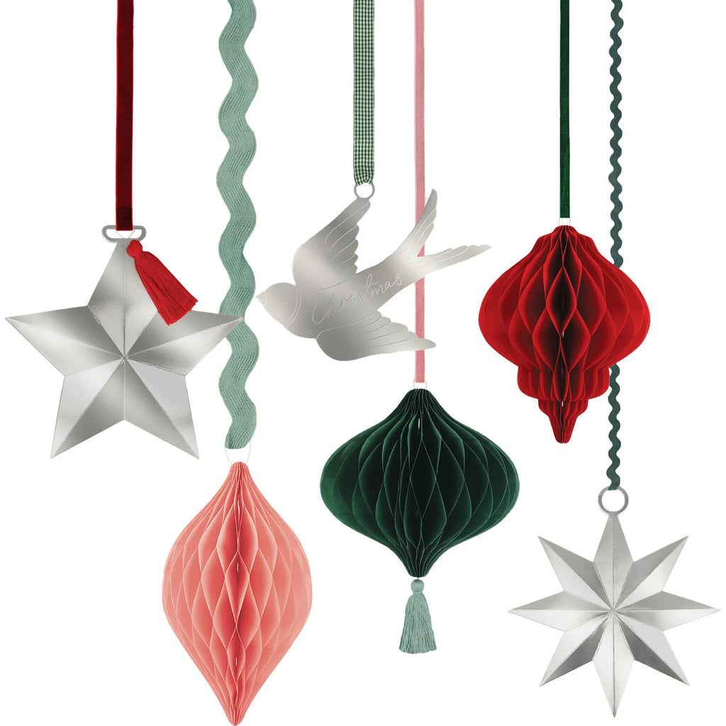 The MeriMeri Large Hanging Decorations collection features luxurious, large Christmas ornaments, including a silver star, a red honeycomb bauble, a pink honeycomb drop, and a green honeycomb ornament. These elegant pieces create a stunning festive backdrop, with each ornament beautifully suspended by colorful ribbons.