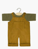 A Minikane Doll Clothing | Antoine Corduroy Overalls Set, featuring a small outfit for Minikane Gordis dolls. The set includes a green short-sleeved shirt and brown corduroy overalls with cuffed legs and a front pocket, both hanging on a wooden hanger with a metal hook. The background is plain white.