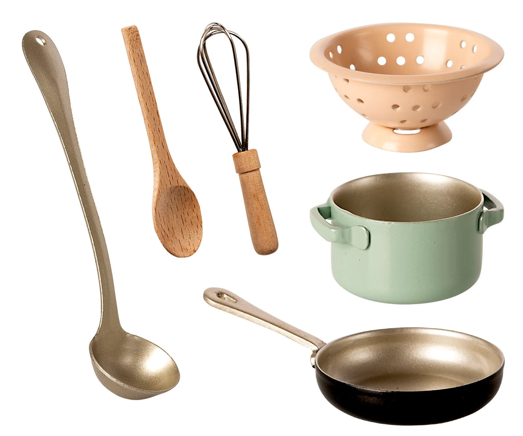 Assortment of kitchen utensils including a Maileg Cooking Set in a playful stove box, isolated on a white background.