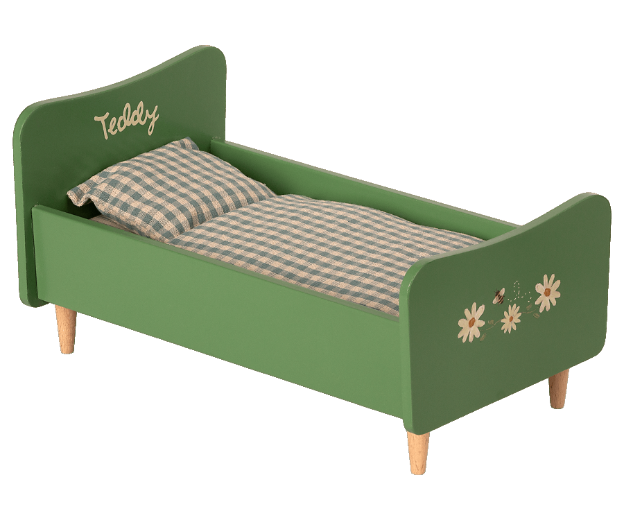 A green wooden Wooden Bed for Teddy Dad - Dusty Green toddler bed with wooden legs, featuring a plaid blanket and 'teddy' written on the headboard, adorned with white daisy decals.