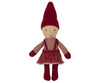 A Maileg Pixy Elfie with a neutral expression is dressed in a red and white plaid jumper over a striped red skirt, red mittens, red shoes, and a tall red pointed hat. The soft and simplistic design of this Christmas friend gives it a handmade appearance, perfect for complementing your Maileg ginger bread house.