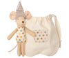 A Maileg Tooth Fairy Little Mouse wearing a polka-dotted outfit and a sparkly hat stands next to a cute little bag with a polka-dotted pocket, perfect for the tooth fairy. The mouse's outfit and the bag's pocket share a colorful polka-dot pattern.