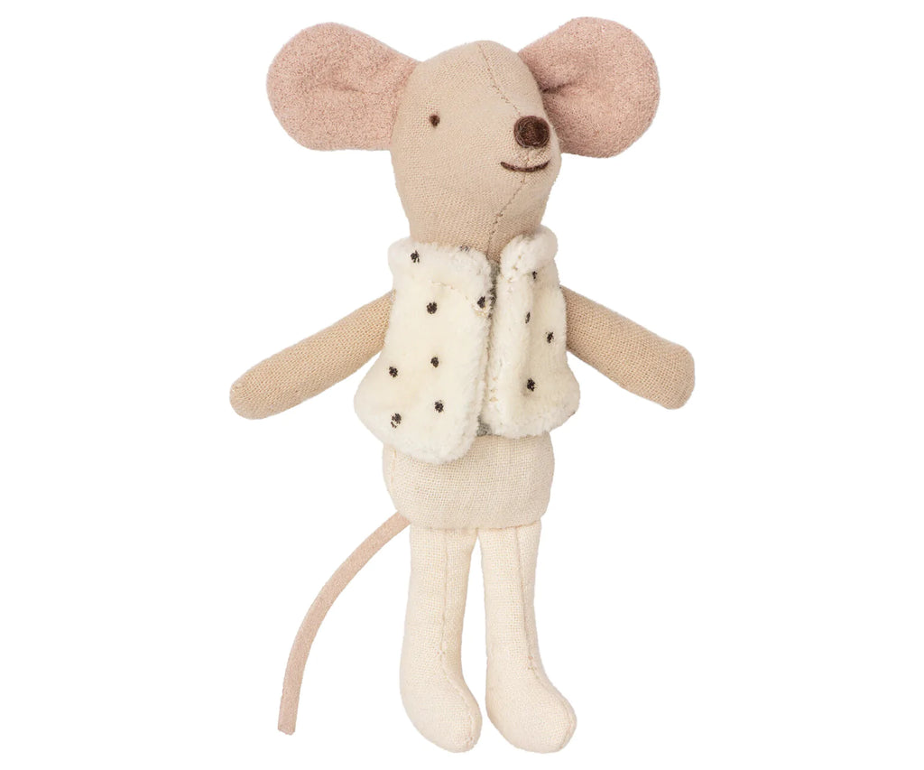 The Maileg Little Brother Dancer Mouse in a Box features a whimsical beige fabric mouse standing with its arms outstretched. It wears an adorable white furry vest adorned with black dots, and its long tail gracefully hangs down. The mouse boasts large, round ears, a stitched nose, and simple detailing that adds to its charming appearance.