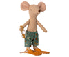 A Maileg Beach Mouse - Big Brother stands upright, wearing teal swim trunks with a botanical print, orange flippers, and holding a pair of swimming goggles. With large round ears and a small pointed snout, this playful and charming mouse is ready for a day at the beach house.