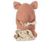 A Maileg Lullaby Friends - Pig (Plays Music) with a pink body and polka-dot ears holds a soft, light-colored blanket adorned with colorful polka-dots. The minimalist design features subtle facial details. This lullaby friends toy sits upright, making it a perfect cuddly and endearing baby gift.