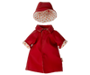 Displayed on a white background is an adorable Maileg Extra Clothing piece: a small, bright red raincoat for Teddy Mum. The raincoat features an attached collar, rolled-up cuffs, and a charming orange polka dot lining. Accompanying the outfit is a matching red rain hat with the same polka dot lining, making it perfect for any Teddy Mum's listing.