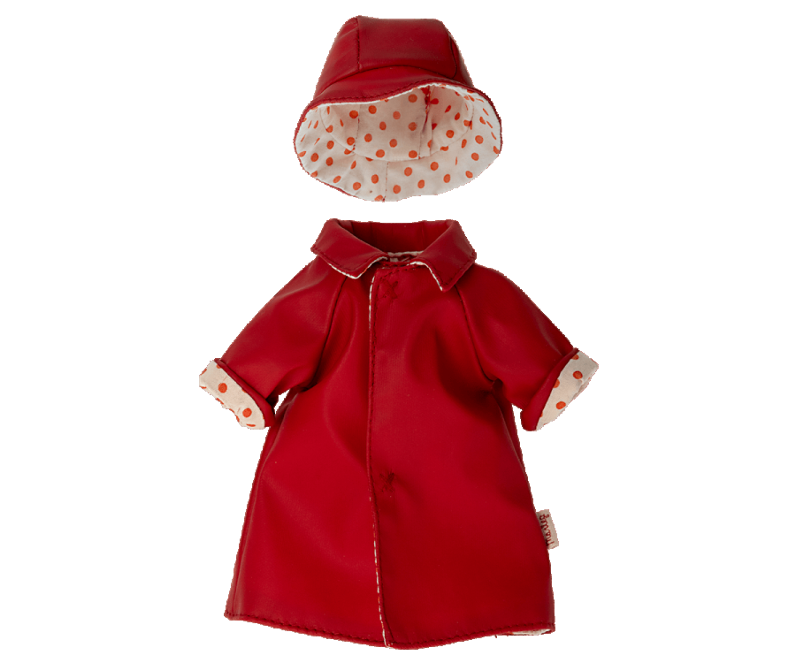 Displayed on a white background is an adorable Maileg Extra Clothing piece: a small, bright red raincoat for Teddy Mum. The raincoat features an attached collar, rolled-up cuffs, and a charming orange polka dot lining. Accompanying the outfit is a matching red rain hat with the same polka dot lining, making it perfect for any Teddy Mum's listing.