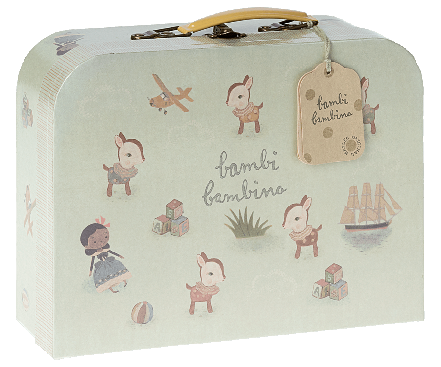 A small, pale green suitcase with a yellow handle features illustrations of playful fawns, a girl with a doll, a toy plane, a ship, a ball, and alphabet blocks. A brown tag attached to the handle reads "Maileg Baby Gift Set," making it perfect as part of a baby gift set.