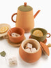 A collection of Handmade Wooden Tea Set - Herbal, including a teapot set and cups with lemon slices and tea bags, arranged on a white background.