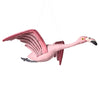 The Hanging Felt Flamingo is a handmade ornament featuring outstretched wings, a black-tipped beak, and yellow eyes. Crafted from organic wool and detailed with darker pink accents using eco-friendly dyes, it creates a whimsical appearance perfect for any decor.