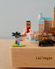 A Las Vegas Wooden Music Box featuring miniature iconic landmarks, including an American-themed music box with a "welcome to las vegas" sign, set against a plain background.