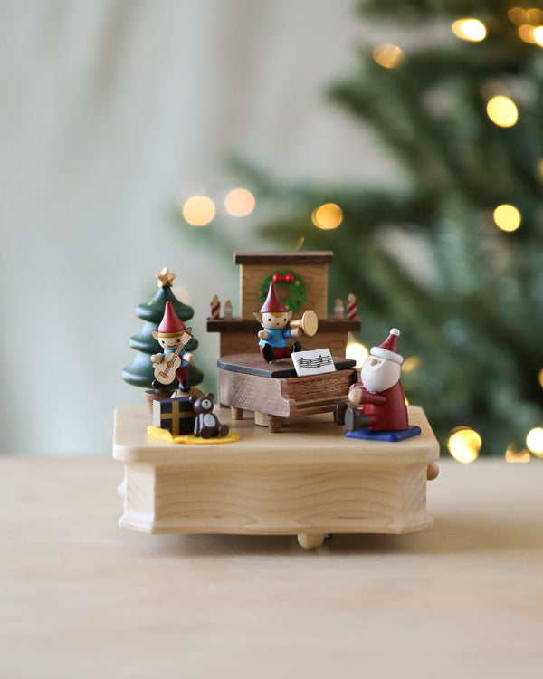 Christmas themed music box with Santa and elves playing music