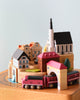 wooden music box with a town in the middle and red train going around it