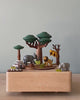 Wooden music box with a tree in the middle with African animals. A small wooden jeep going around the music box. 