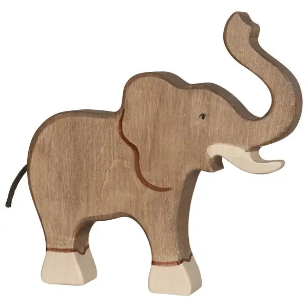 A handcrafted wooden Holztiger Elephant, Trunk Raised with a minimalist design. The light brown elephant, featuring lighter colored tusks and feet, raises its trunk upward while simple facial features are carved into the wood. Made in Europe, it's reminiscent of HOLZTIGER figures.