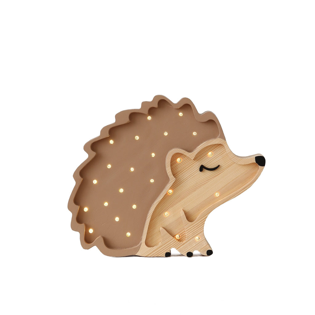 The Little Lights Hedgehog Lamp boasts a light brown body with a darker brown spiky outline and a serene, closed-eye expression, making it the perfect whimsical children's night light.