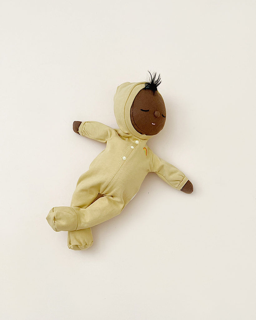 Sleeping doll in yellow pajamas. 