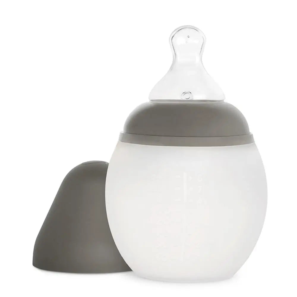 A Medical Grade Silicone Baby Bottle designed to mimic breastfeeding with a detachable frosted bottom and a clear BPA-free silicone nipple, isolated on a white background.