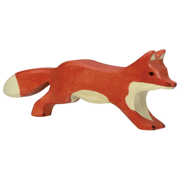 A handcrafted wooden Holztiger Running Fox, painted in shades of red with a white underbelly, white-tipped tail, and black eyes. Made in Europe, the figurine depicts the fox in a playful, crouching stance, ready to pounce. Part of the HOLZTIGER figures collection known for their quality and charm.