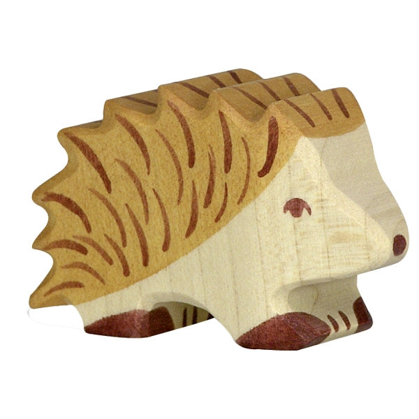 A small, handcrafted Holztiger Hedgehog with natural wood tones. The hedgehog, part of the HOLZTIGER figures collection and made in Europe, has carved details for its quills with brown and tan accents. Its simple painted face includes a dot for the nose and a line for the eye.