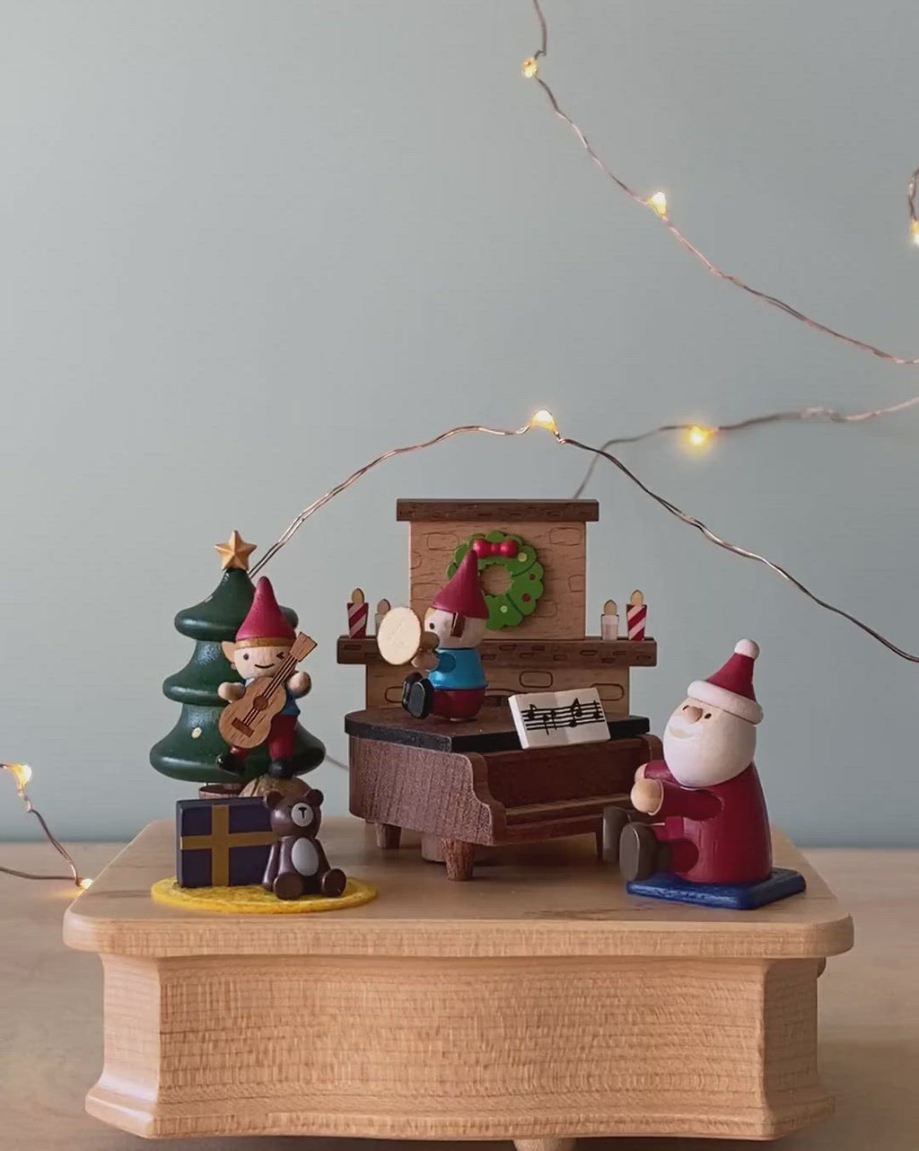 Christmas themed music box with Santa and elves playing music