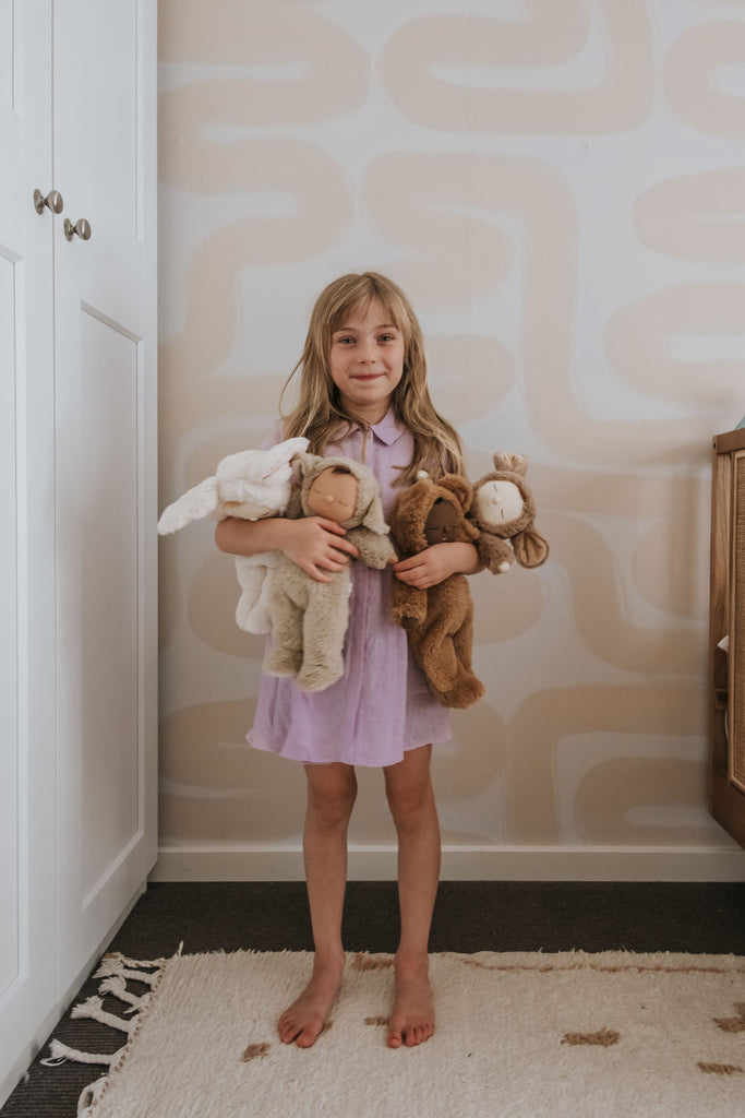 kid holding baby dolls