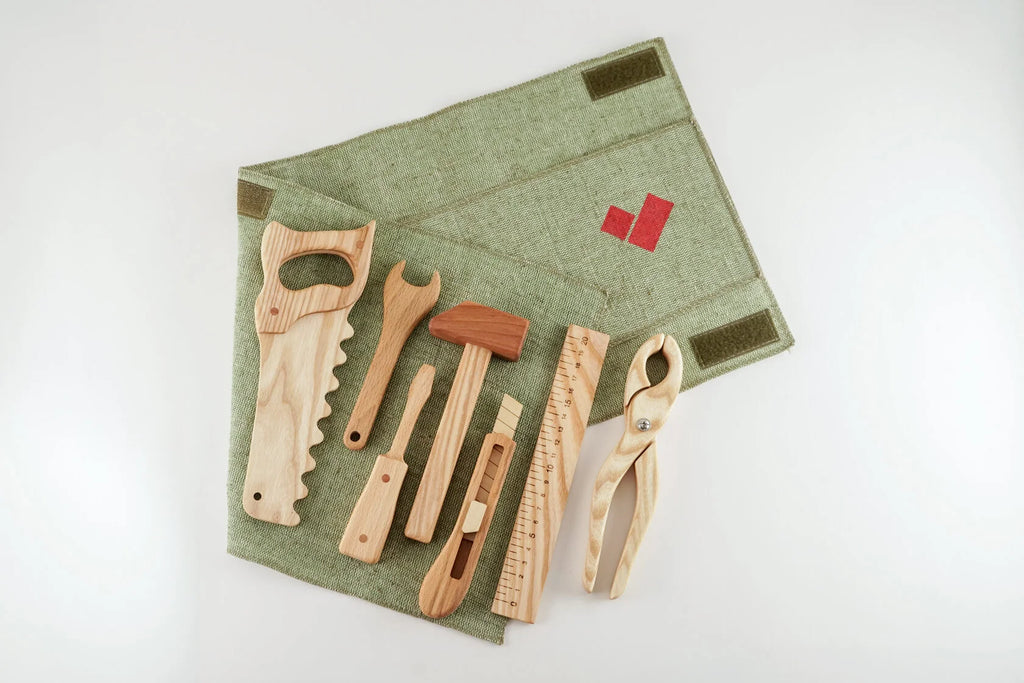 Seven wooden tool toys in a rollup canvas. 