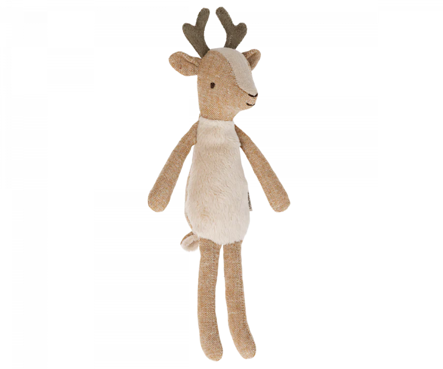 A small deer stuffed animal with antlers photographed on a flat background.